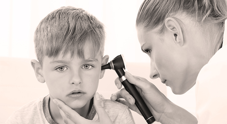 Close-up Of Female Doctor Examining Boy's Ear With An Otoscope